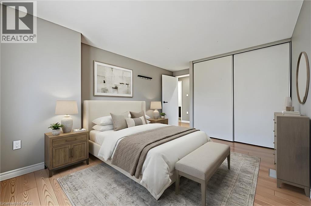 Spacious room featuring wood-finish flooring, light gray wall tones, and white trim - 365 Pioneer Drive Unit# 25, Kitchener, ON - Indoor Photo Showing Bedroom