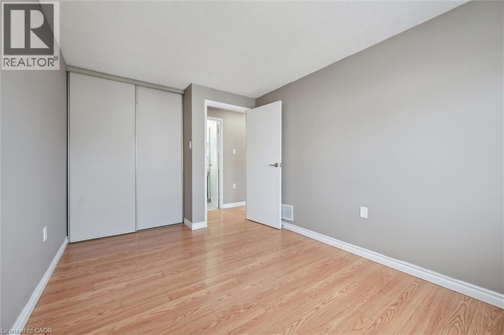 Room featuring wood-finish flooring, light grey painted walls, and white baseboards - 365 Pioneer Drive Unit# 25, Kitchener, ON - Indoor Photo Showing Other Room
