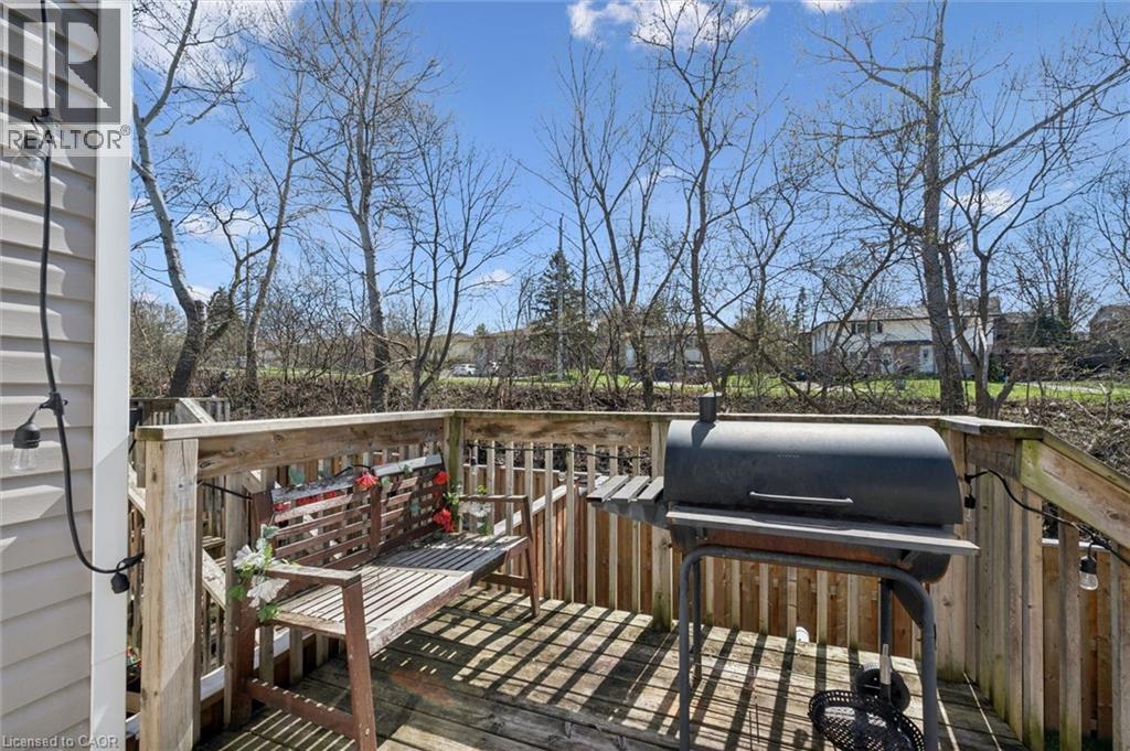 Outdoor deck featuring wood railing and decking - 365 Pioneer Drive Unit# 25, Kitchener, ON - Outdoor With Deck Patio Veranda