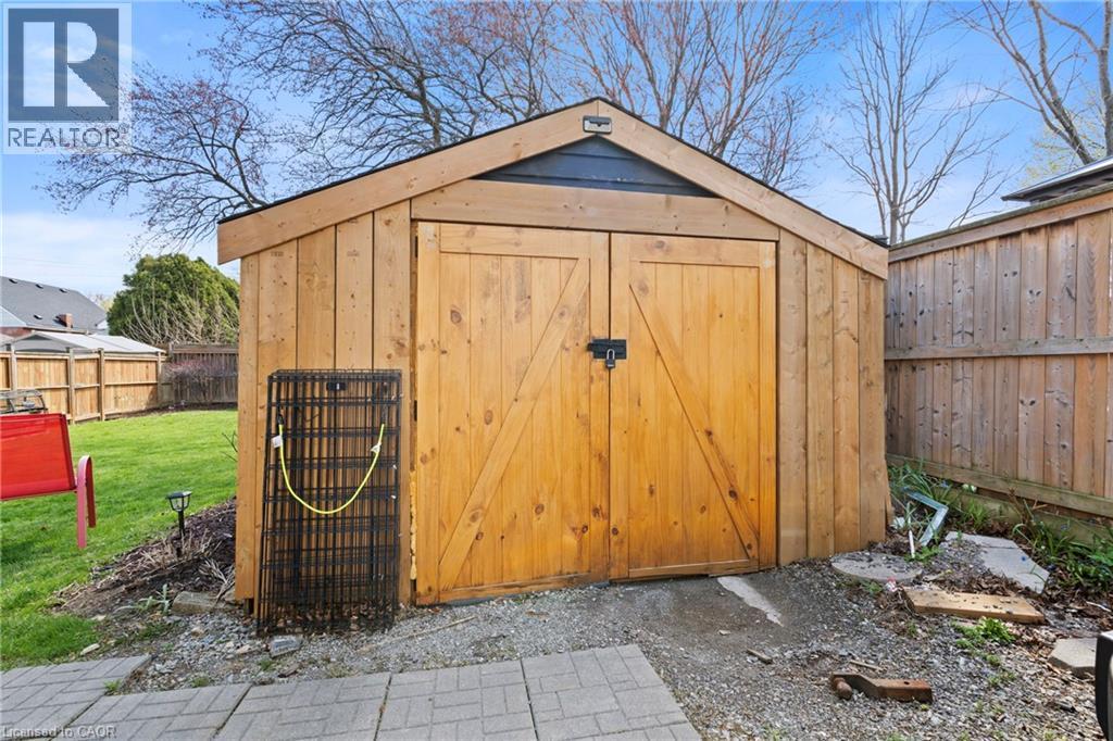 Wood-sided storage shed with a gabled roof and double barn doors - 25 East 39Th Street, Hamilton, ON - Outdoor
