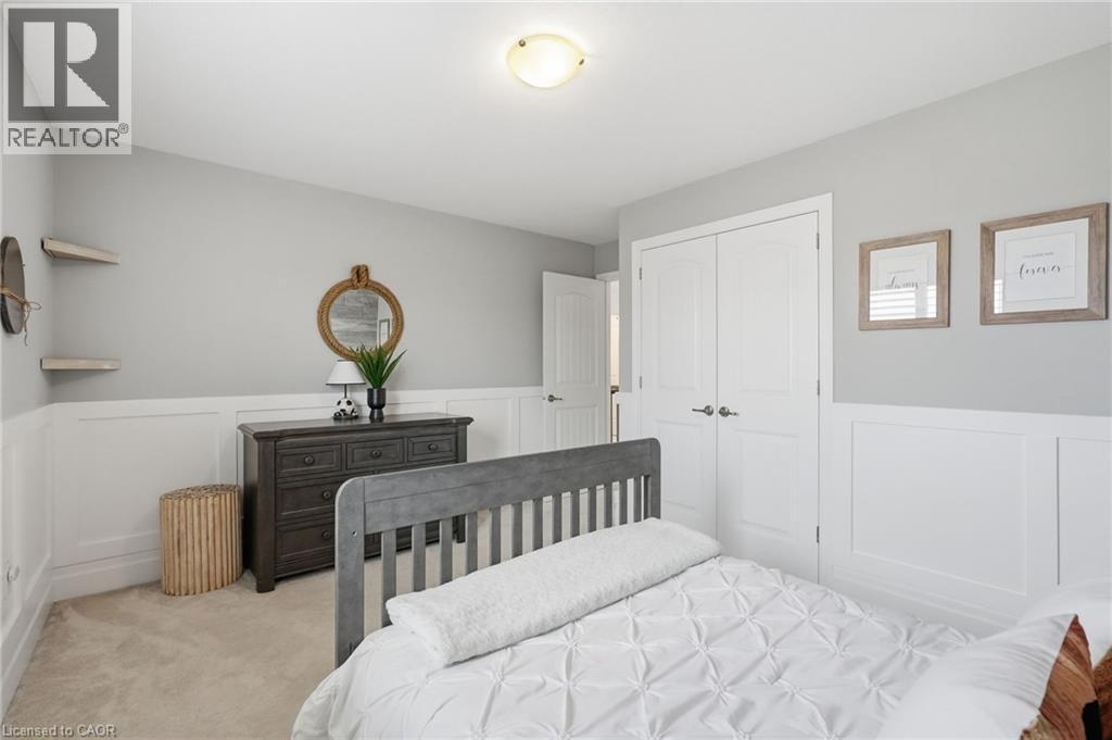 Bedroom featuring wainscoting and light gray wall paint - 47 Winners Way, Binbrook, ON - Indoor Photo Showing Bedroom