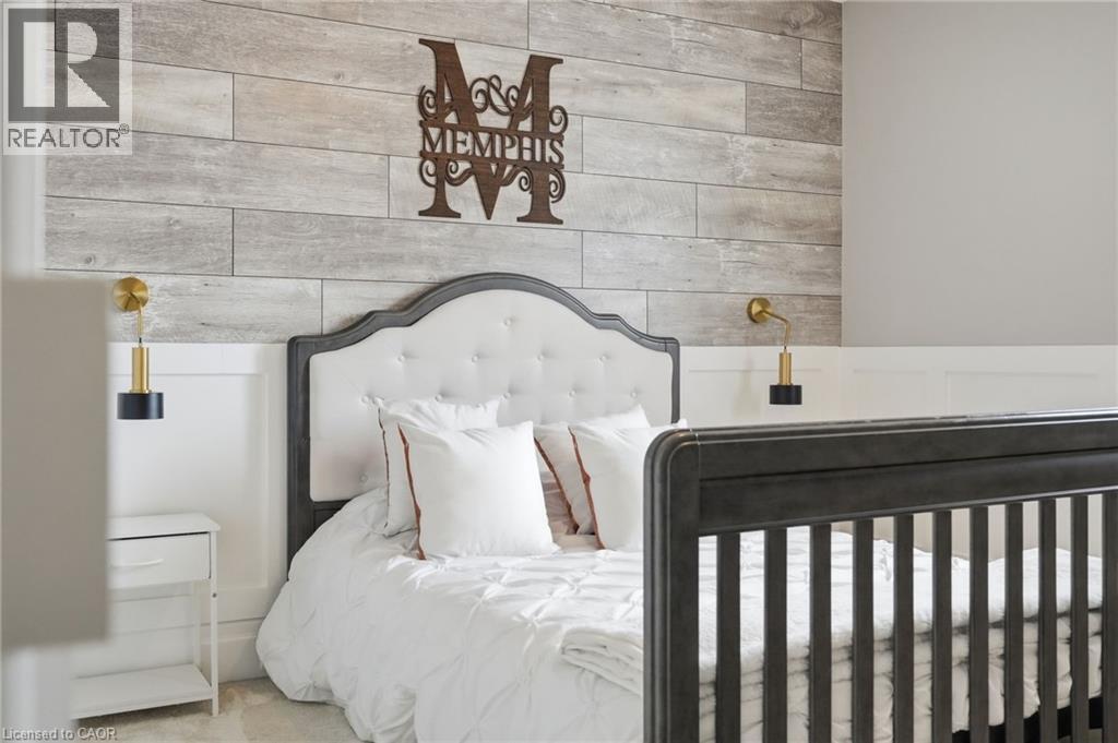 Accent wall featuring horizontal wood-finish paneling above a white wainscoting - 47 Winners Way, Binbrook, ON - Indoor Photo Showing Bedroom