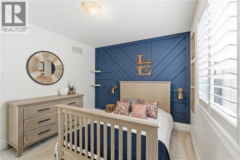 Accent wall featuring a geometric wood panel design and a rich blue finish - 47 Winners Way, Binbrook, ON - Indoor Photo Showing Bedroom