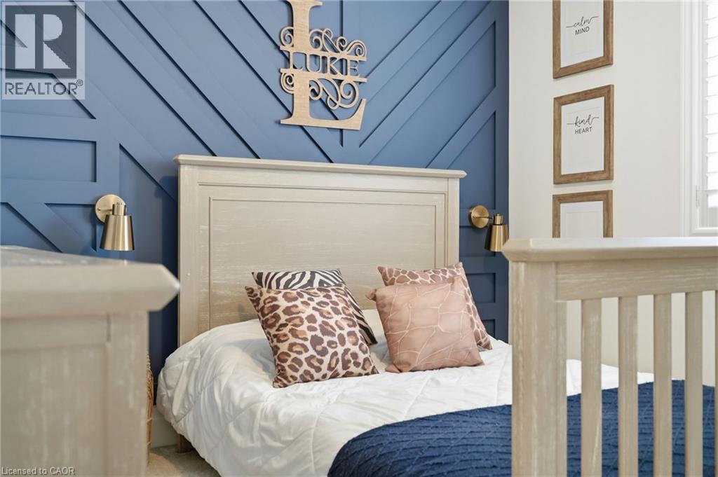 Accent wall with geometric paneling, featuring a light-toned wooden headboard, brushed brass wall sconces, and white window shutters - 47 Winners Way, Binbrook, ON - Indoor Photo Showing Bedroom