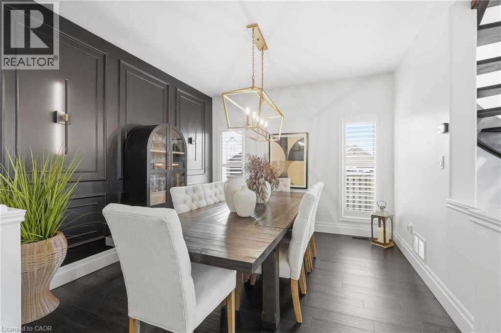 Formal dining area featuring dark wood-finish flooring - 47 Winners Way, Binbrook, ON - Indoor Photo Showing Dining Room