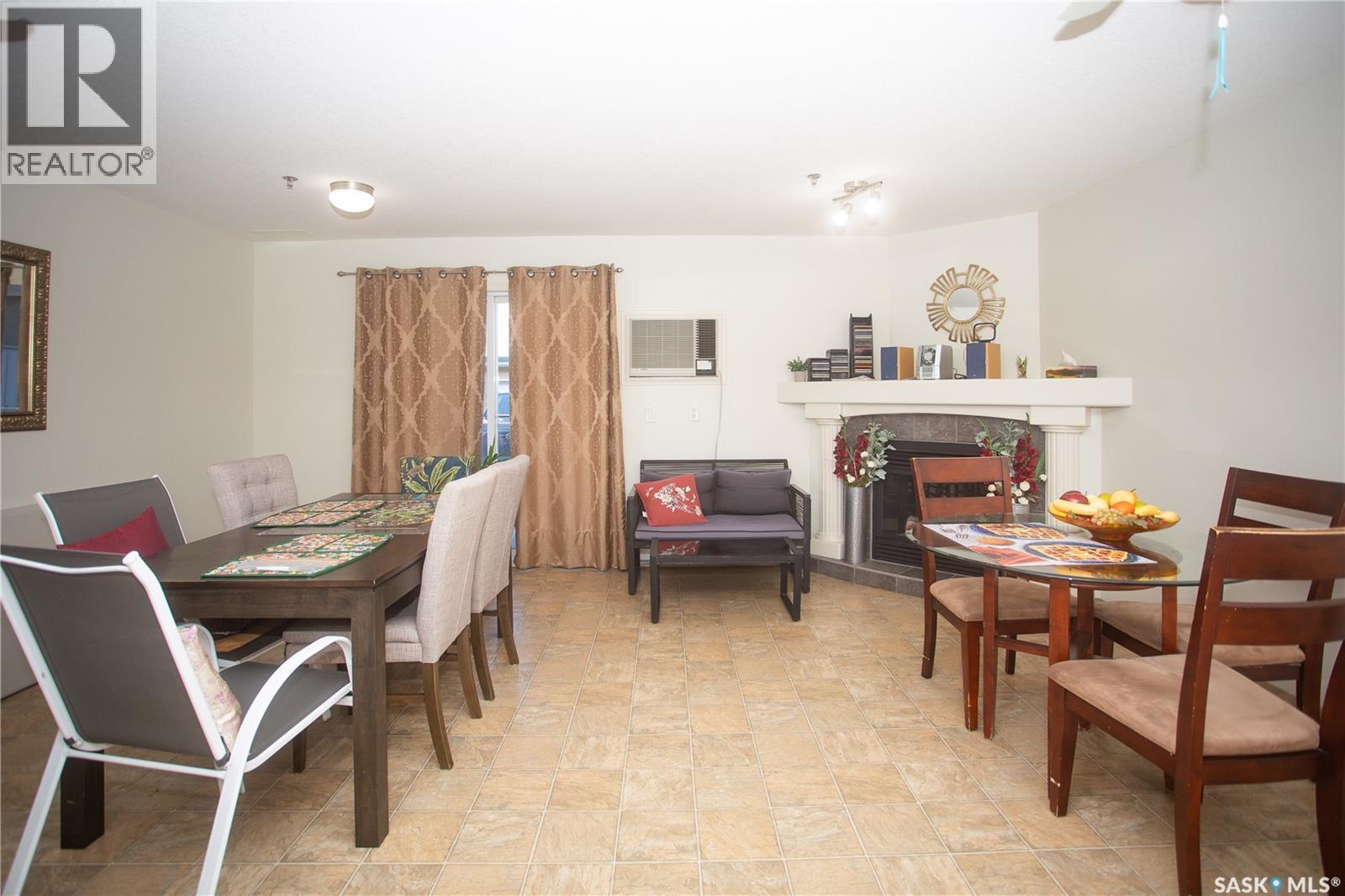 411 215 Lowe Road, Saskatoon, SK - Indoor Photo Showing Dining Room With Fireplace
