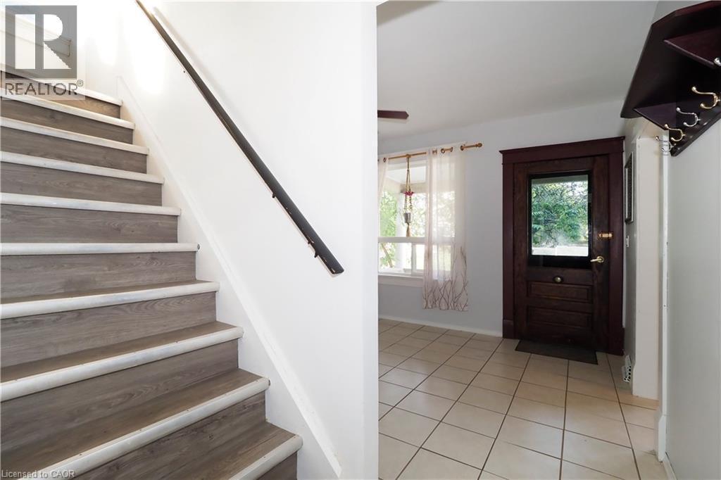Entryway featuring light-toned tile flooring and a dark wood-finish door with a glass panel - 205 Duke Street E, Kitchener, ON - Indoor Photo Showing Other Room