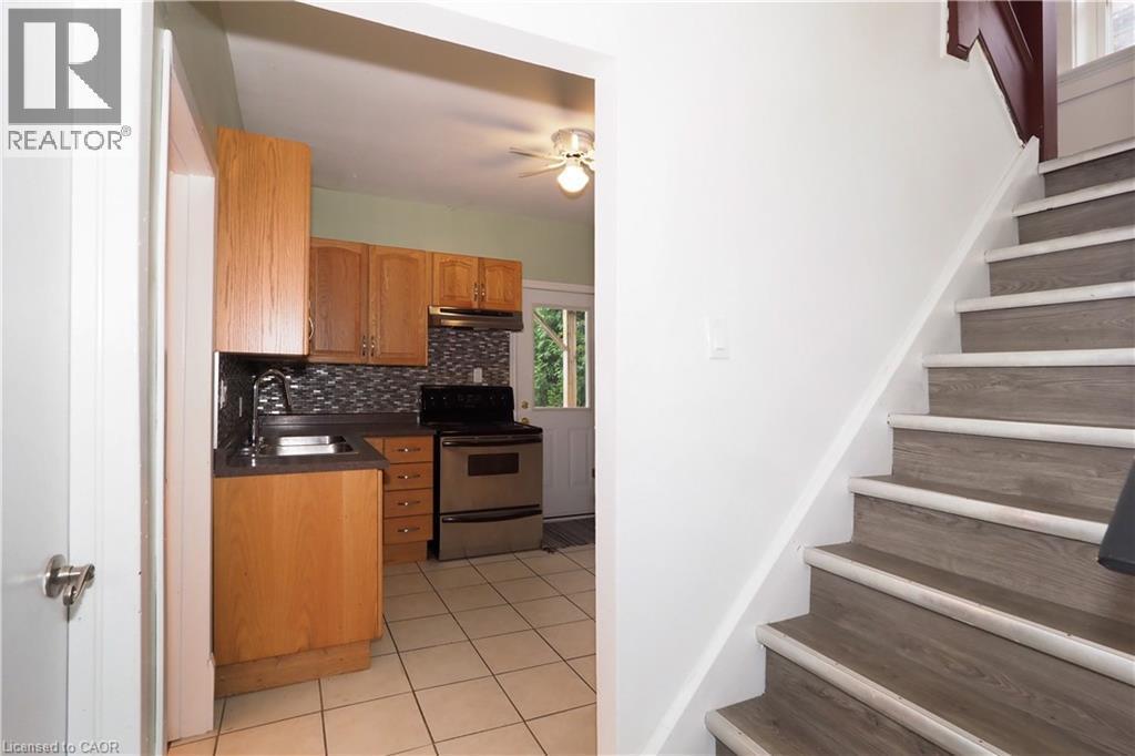 Wood-finish staircase with white risers and trim - 205 Duke Street E, Kitchener, ON - Indoor