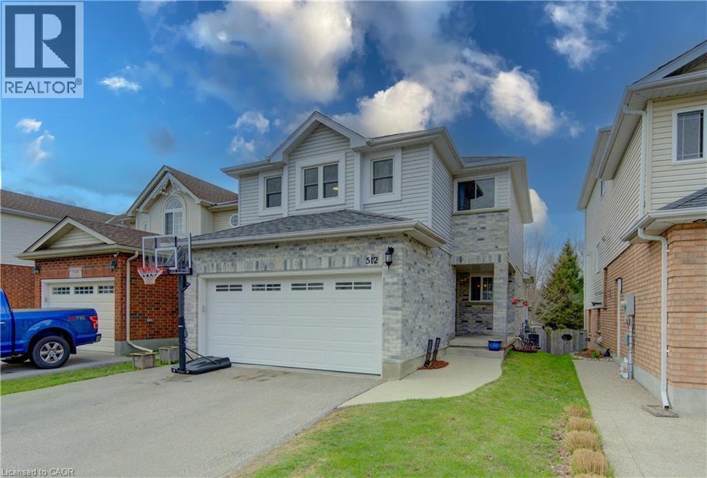 Two-story residence featuring a stone facade and light-colored siding - 512 Hidden Creek Drive, Kitchener, ON - Outdoor