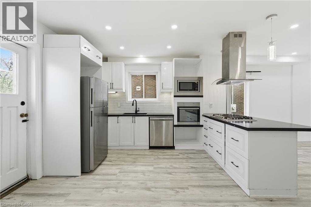 Spacious kitchen with access to yard - 73 Gertrude Street, Hamilton, ON - Indoor Photo Showing Kitchen With Upgraded Kitchen