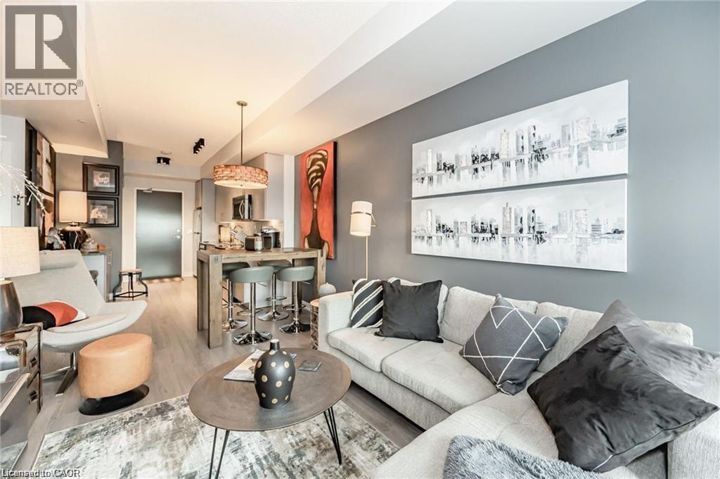 Open-concept living area featuring light wood-finish flooring - 85 Duke Street W Unit# 507, Kitchener, ON - Indoor Photo Showing Living Room