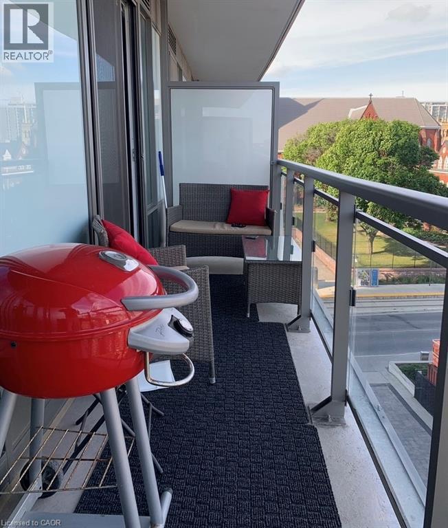 Private balcony featuring glass railings and a textured floor mat - 85 Duke Street W Unit# 507, Kitchener, ON - Outdoor With Balcony With Exterior