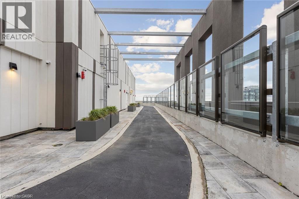 Rooftop walkway featuring a paved surface bordered by concrete pavers - 85 Duke Street W Unit# 507, Kitchener, ON - Indoor Photo Showing Other Room