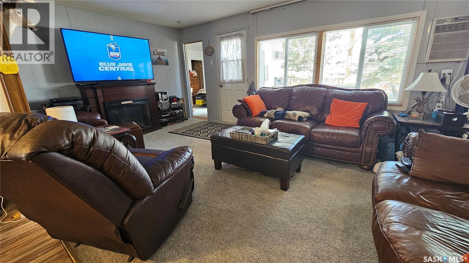97 Ferguson Bay, Reid Lake, SK - Indoor Photo Showing Living Room With Fireplace