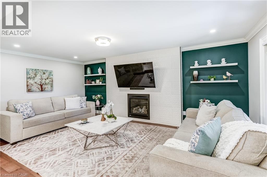 Living area featuring a modern fireplace with a textured white surround, recessed lighting, and crown molding - 1264 Kane Road, Mississauga, ON - Indoor Photo Showing Living Room With Fireplace