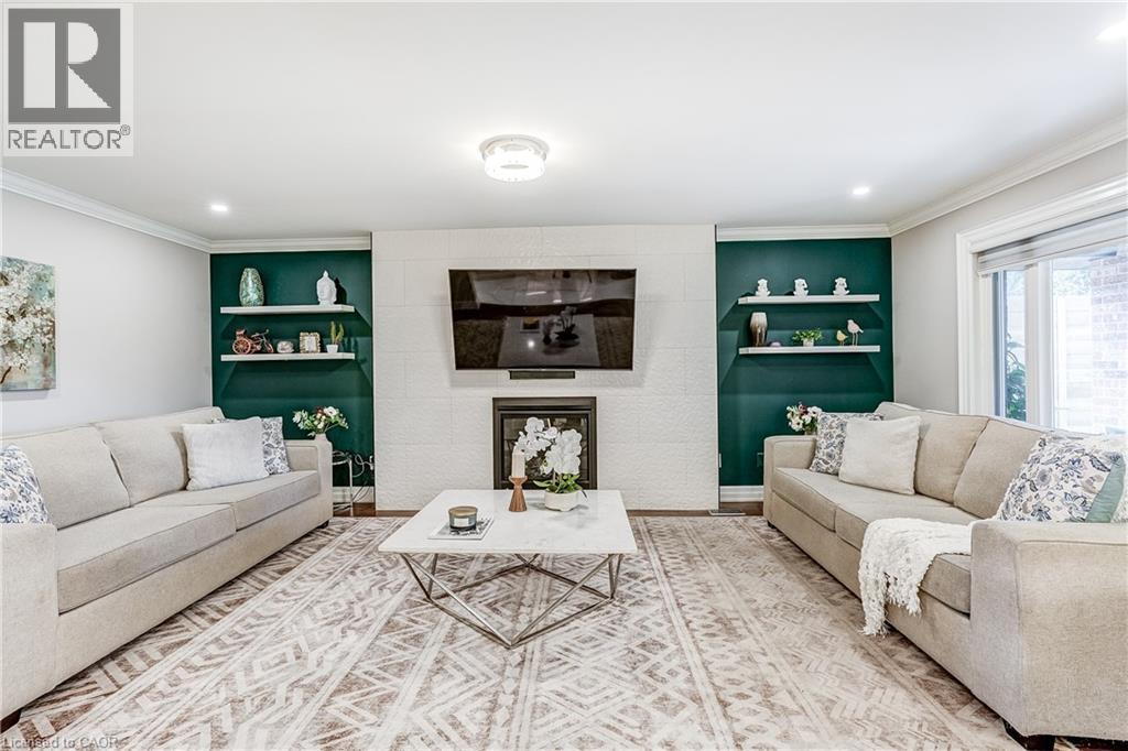Living area with a white brick-style fireplace surround and a recessed black firebox - 1264 Kane Road, Mississauga, ON - Indoor Photo Showing Living Room With Fireplace