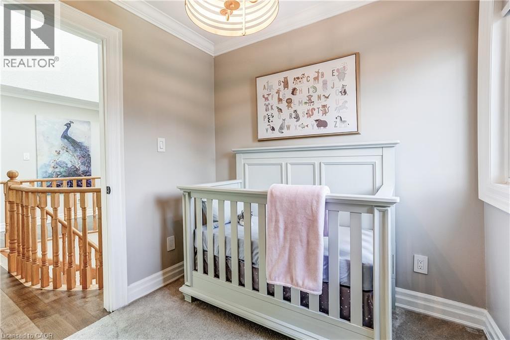 Carpeted room with crown molding, a decorative ceiling light fixture, and a window - 1264 Kane Road, Mississauga, ON - Indoor Photo Showing Bedroom