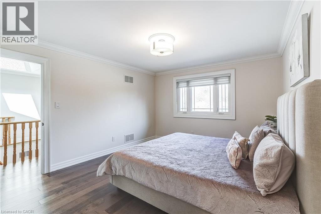 Bedroom featuring wood-finish flooring, white crown molding, and a window with white trim - 1264 Kane Road, Mississauga, ON - Indoor Photo Showing Bedroom