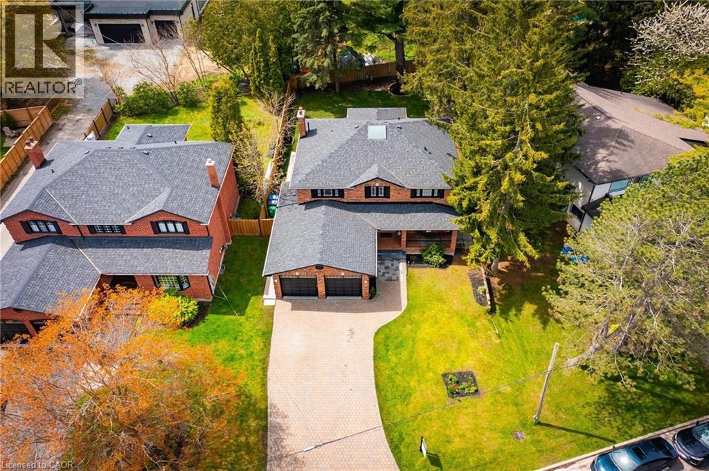Brick two-story residence featuring a dark gray shingle roof and a two-car garage - 1264 Kane Road, Mississauga, ON - Outdoor