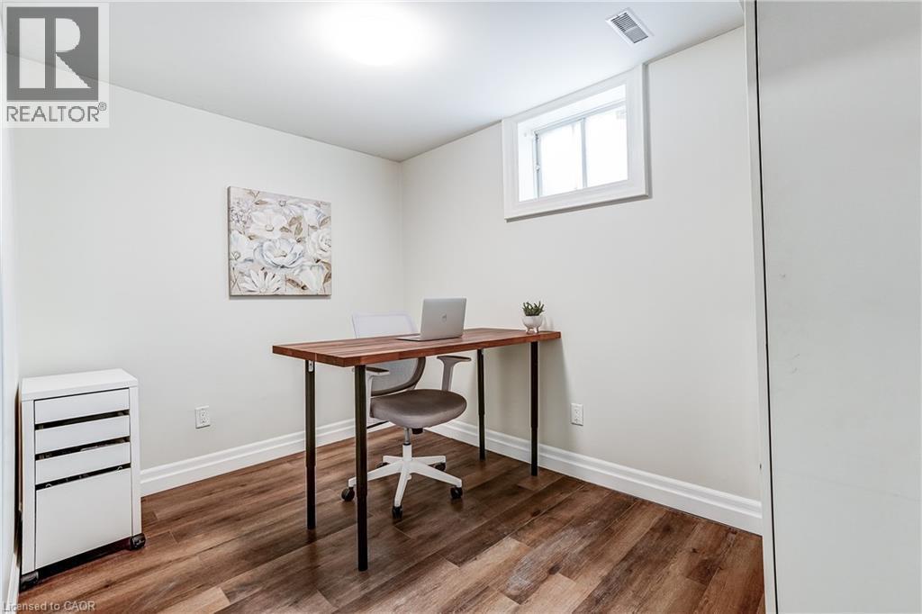 Bright room featuring wood-finish flooring, white baseboards, a high-set window, and a flush-mount ceiling light - 1264 Kane Road, Mississauga, ON - Indoor Photo Showing Office