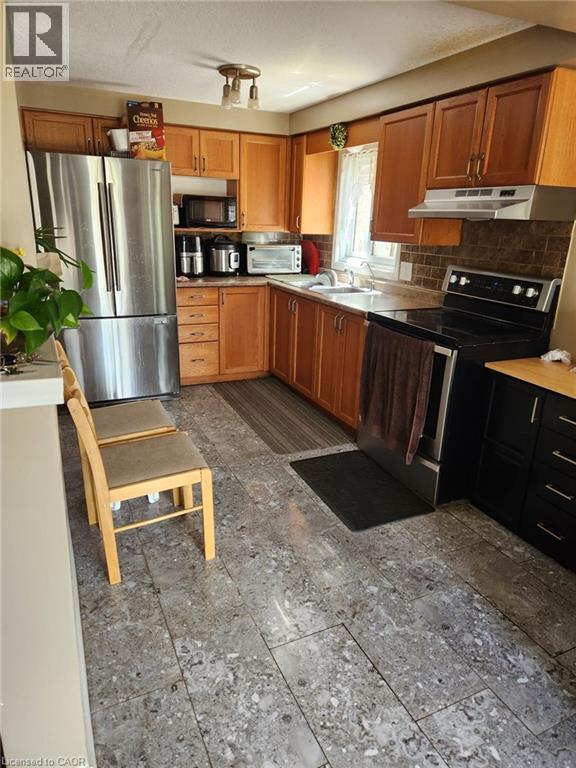 Kitchen featuring light wood cabinetry and a stainless steel refrigerator - 1126 Copper Leaf Crescent, Kitchener, ON - Indoor Photo Showing Kitchen