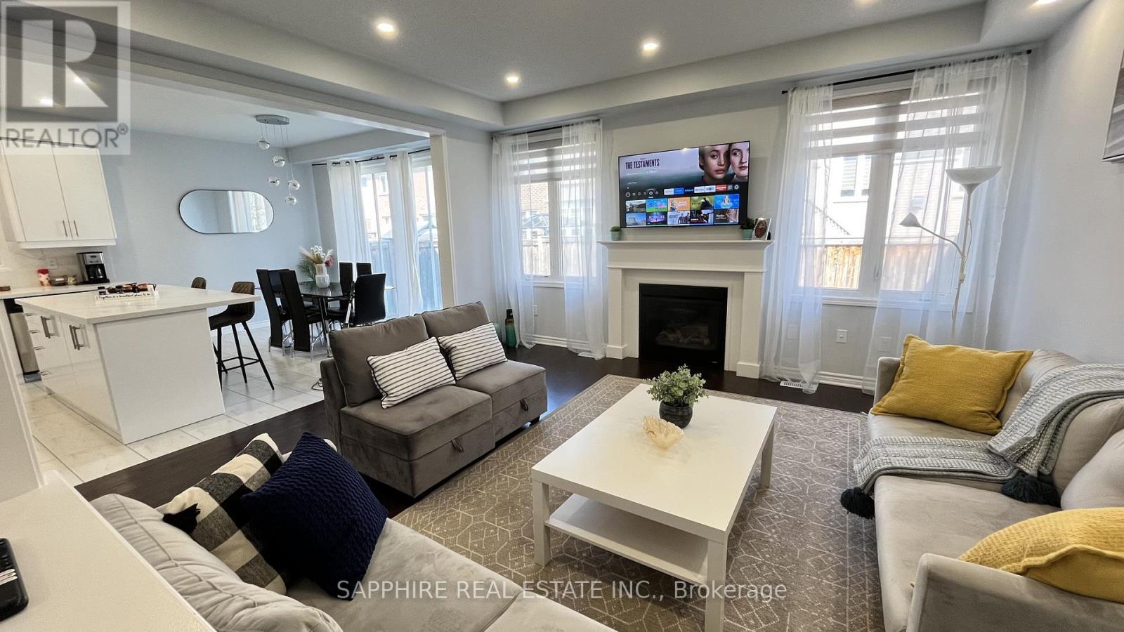 Open Concept Family Dining and Kitchen - 325 Trudeau Drive E, Milton, ON - Indoor Photo Showing Living Room With Fireplace