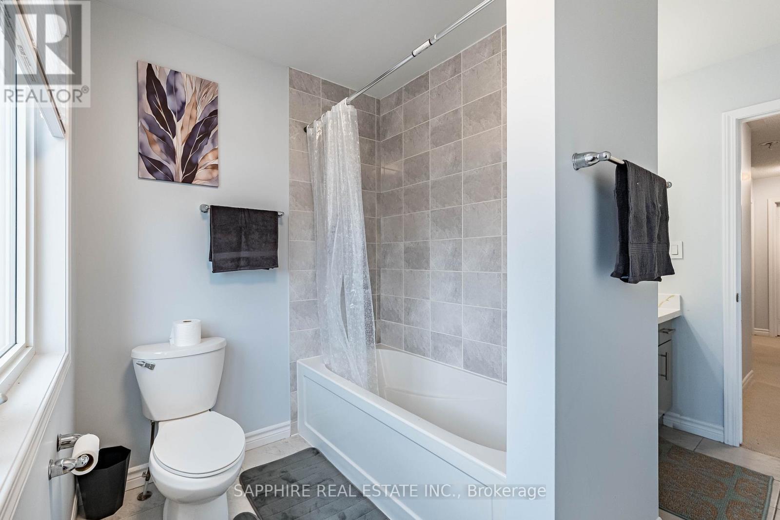 Common Washroom with Large window and Tub - 325 Trudeau Drive E, Milton, ON - Indoor Photo Showing Bathroom