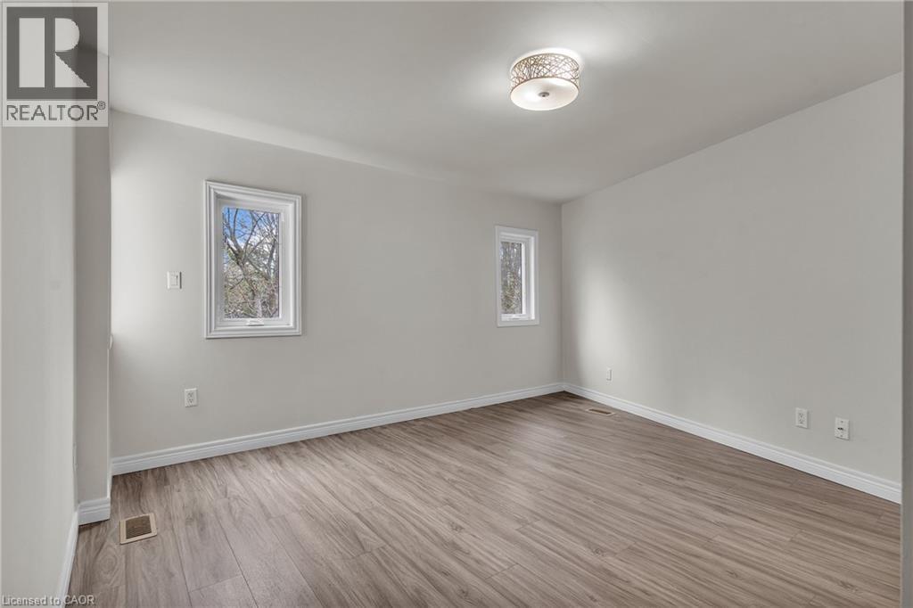Interior room featuring light gray walls, wood-finish flooring, and white trim - 22 Blackhorne Crescent, Kitchener, ON - Indoor Photo Showing Other Room
