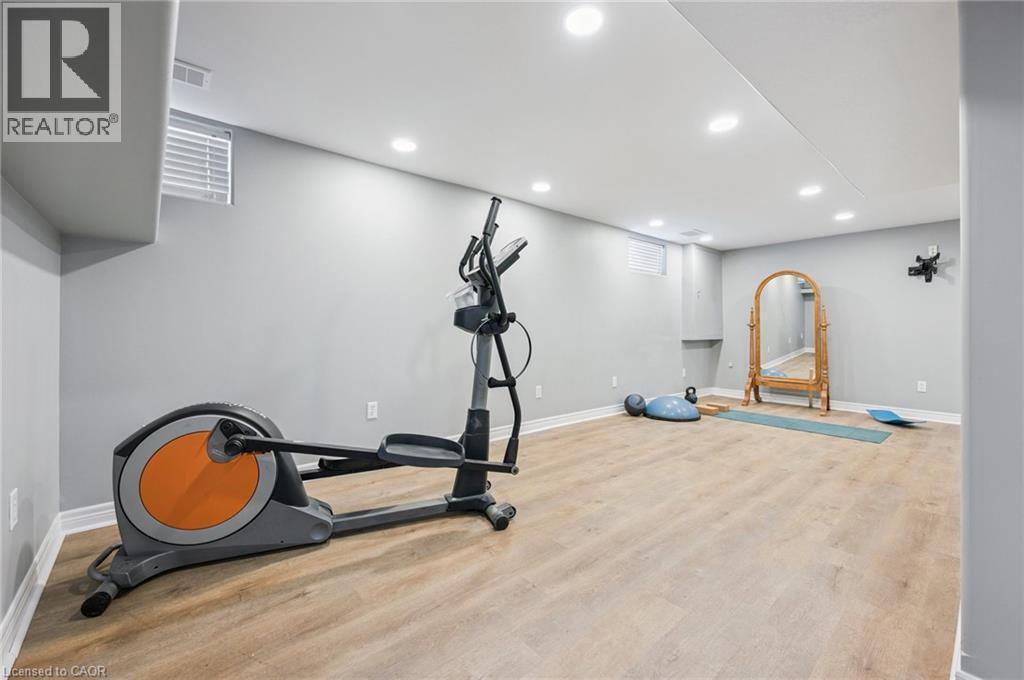 Spacious room with light wood-finish flooring, recessed lighting, and light grey painted walls - 838 Moore Street, Cambridge, ON - Indoor Photo Showing Gym Room