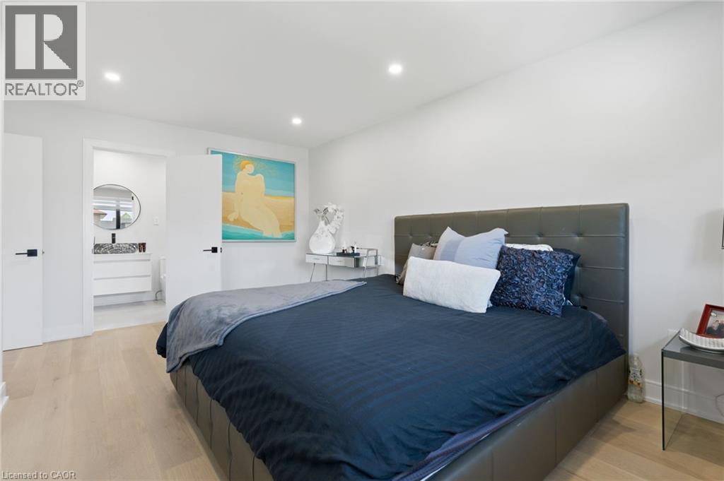 Bedroom featuring light wood finished floors, recessed lighting, and connected bathroom - 17 Clearview Drive, Hamilton, ON - Indoor Photo Showing Bedroom
