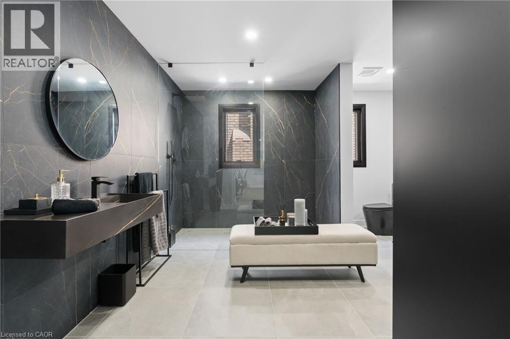 Full bathroom featuring tile walls, a walk in shower, vanity, recessed lighting, and stone wall - 17 Clearview Drive, Hamilton, ON - Indoor