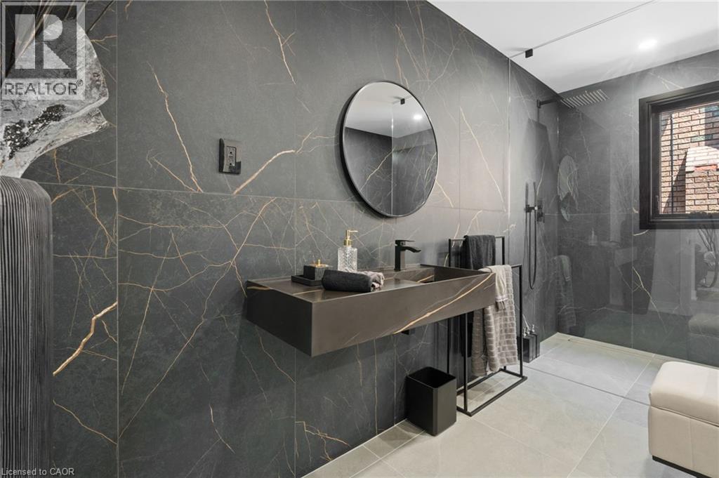 Modern bathroom featuring large-format dark stone-look wall tiles with gold veining - 17 Clearview Drive, Hamilton, ON - Indoor Photo Showing Bathroom