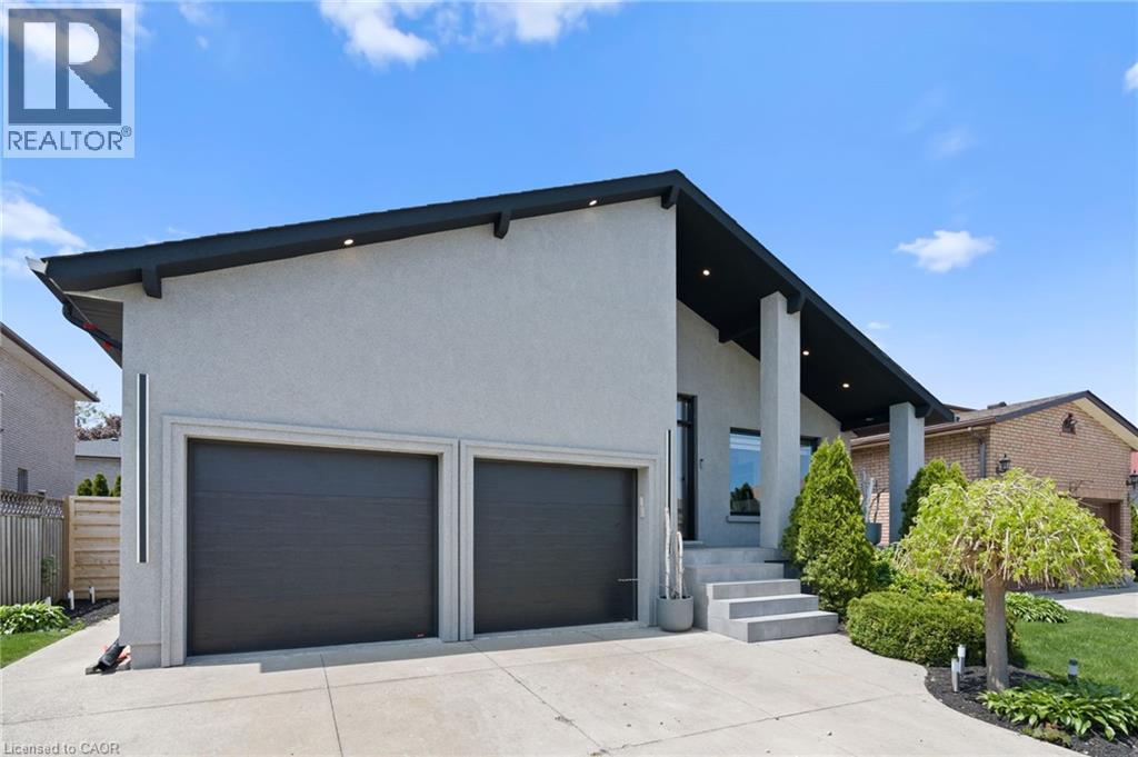 Contemporary exterior with a prominent A-frame roofline and light stucco finish - 17 Clearview Drive, Hamilton, ON - Outdoor