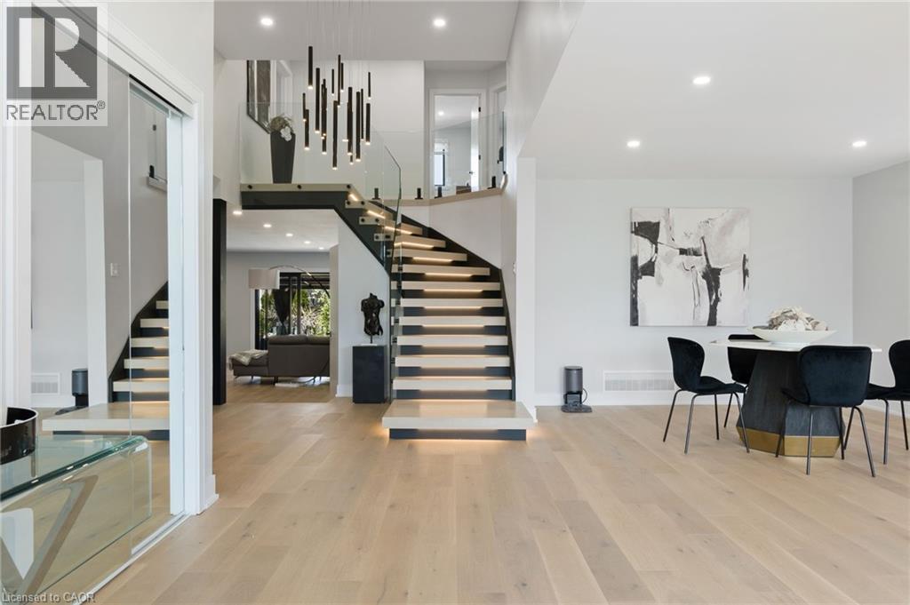 Dining room featuring stairway, recessed lighting, light wood-style flooring, and a towering ceiling - 17 Clearview Drive, Hamilton, ON - Indoor