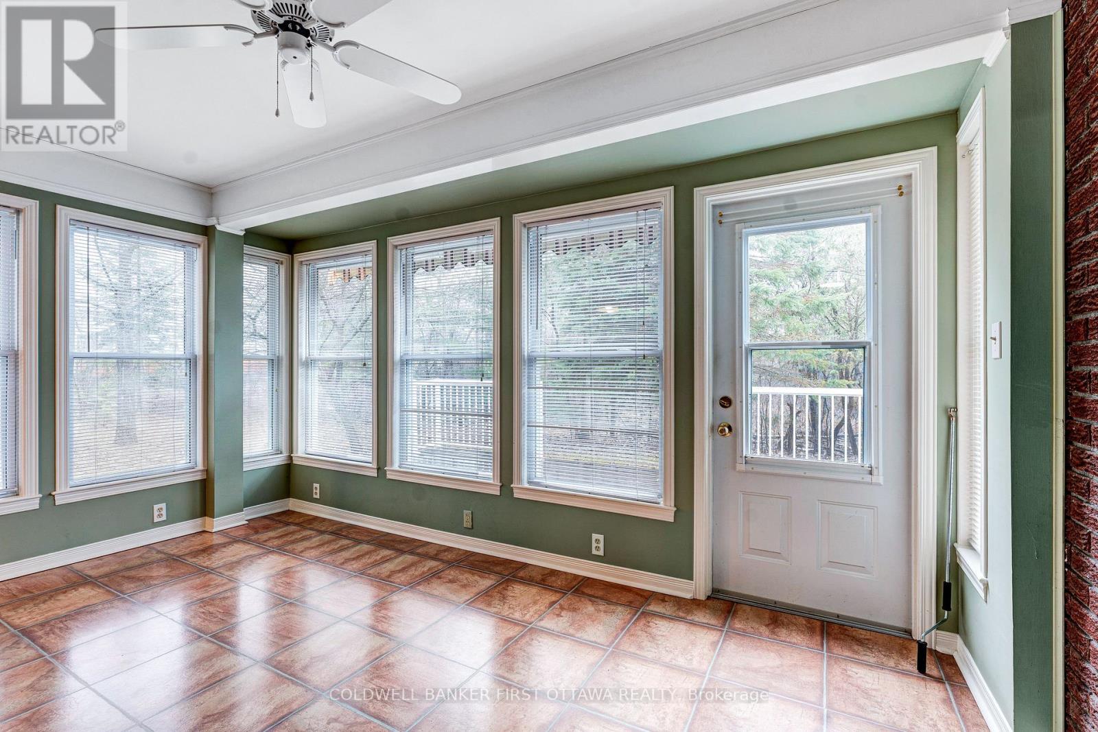 Sunroom walls of windows & door to backyard - 12 Glenview Crescent, Perth, ON - Indoor Photo Showing Other Room