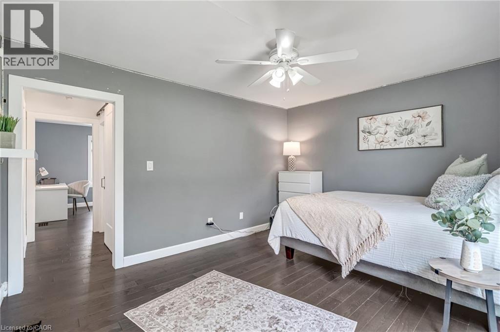 Room featuring dark wood-finish flooring, light gray wall paint, and white trim - 2123 Deyncourt Drive, Burlington, ON - Indoor Photo Showing Bedroom