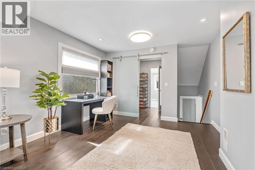 Interior space featuring dark wood-finish flooring, light gray wall paint, and white baseboards - 2123 Deyncourt Drive, Burlington, ON - Indoor