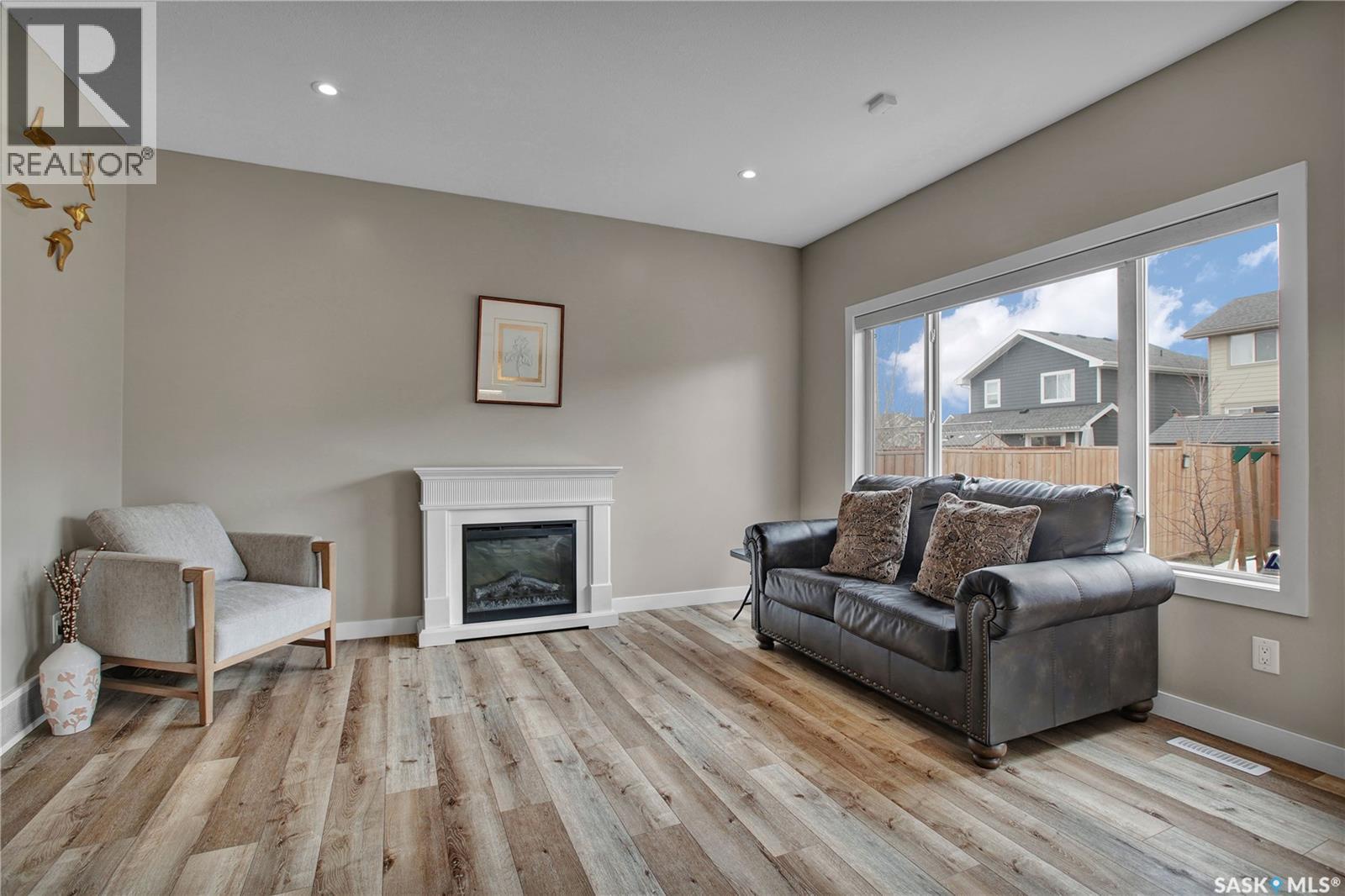 211 Stilling Union, Saskatoon, SK - Indoor Photo Showing Living Room With Fireplace