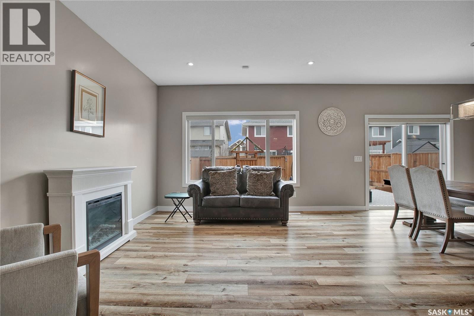 211 Stilling Union, Saskatoon, SK - Indoor Photo Showing Living Room With Fireplace