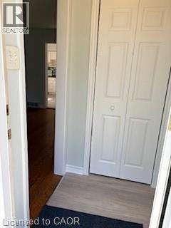 Entryway featuring light wood-finish flooring, white bi-fold closet doors, and wood flooring extending into the interior - 648 Francis Road, Burlington, ON - Indoor Photo Showing Other Room