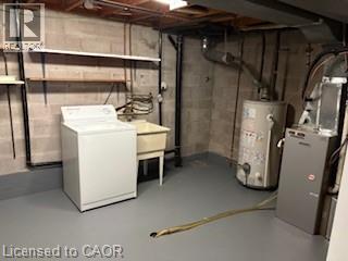 Utility area featuring a laundry sink, exposed structural elements, and concrete block walls - 648 Francis Road, Burlington, ON - Indoor