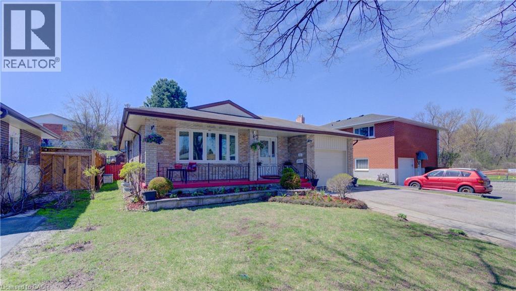 Brick exterior with a covered front porch featuring a dark railing - 170 Martinglen Crescent, Kitchener, ON - Outdoor