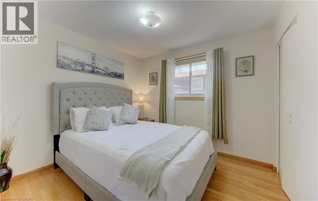 Bright interior with wood-finish flooring - 170 Martinglen Crescent, Kitchener, ON - Indoor Photo Showing Bedroom