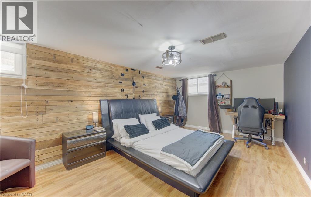 Accent wall with horizontal wood paneling and light wood-finish flooring - 170 Martinglen Crescent, Kitchener, ON - Indoor Photo Showing Bedroom