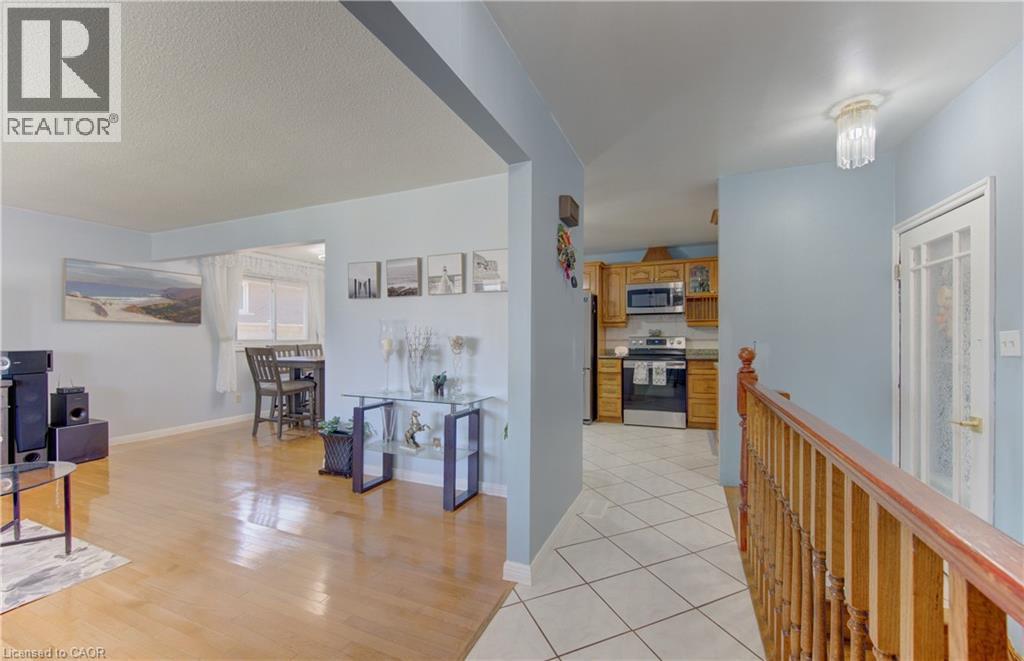 Open-concept living space with light-tone wood-finish flooring - 170 Martinglen Crescent, Kitchener, ON - Indoor Photo Showing Other Room