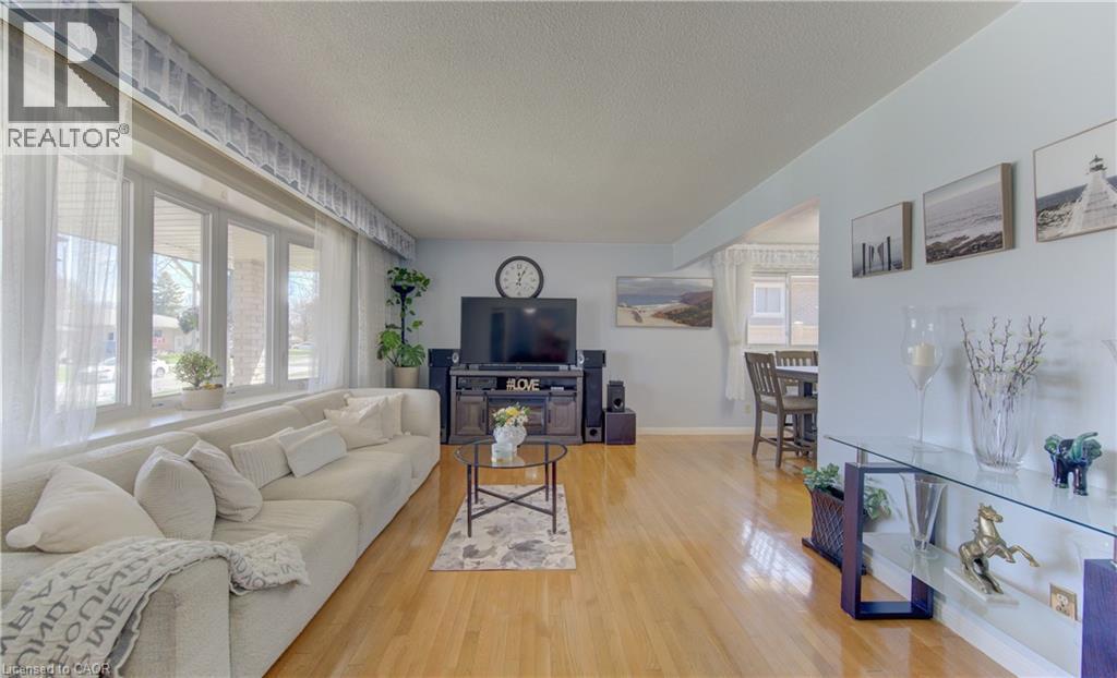 Living area featuring wood-finish flooring and a large picture window - 170 Martinglen Crescent, Kitchener, ON - Indoor Photo Showing Living Room