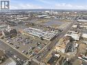 Commercial building featuring a flat roofline, extensive surface parking, and prominent street frontage - 869 Barton Street E, Hamilton, ON 