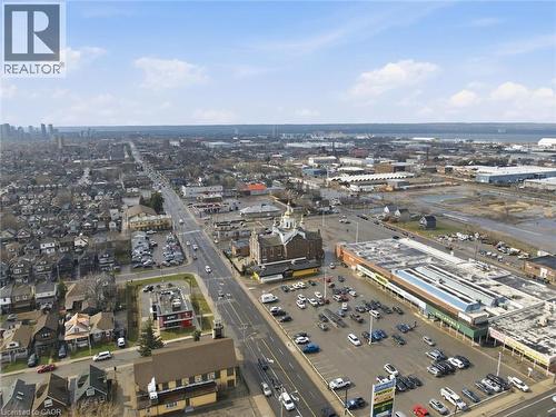 Expansive aerial perspective showcasing a major thoroughfare with commercial establishments and residential areas - 869 Barton Street E, Hamilton, ON 