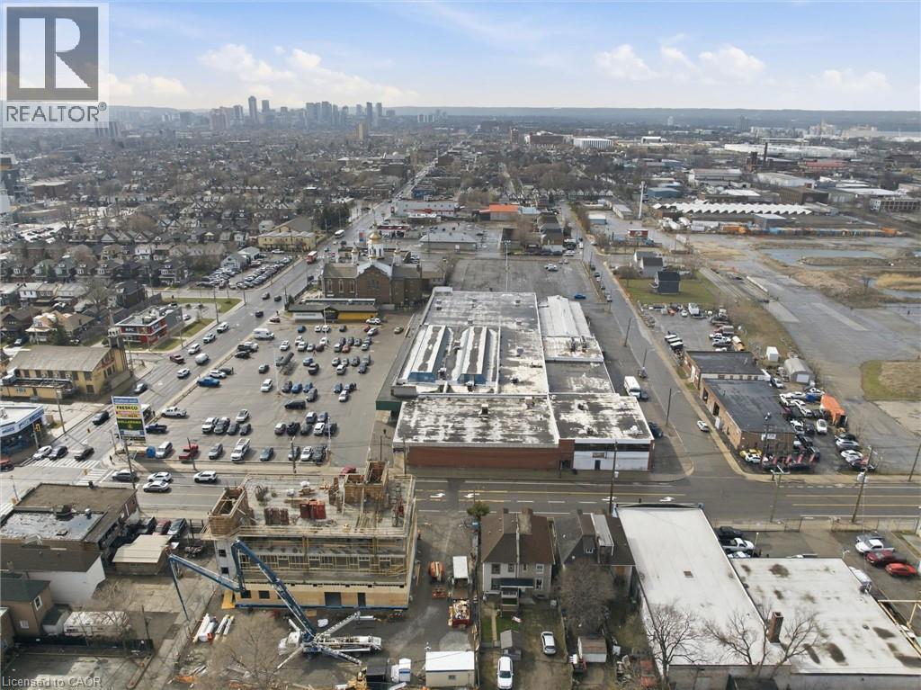 Aerial perspective showcasing urban and suburban landscapes with a distant city skyline - 869 Barton Street E, Hamilton, ON