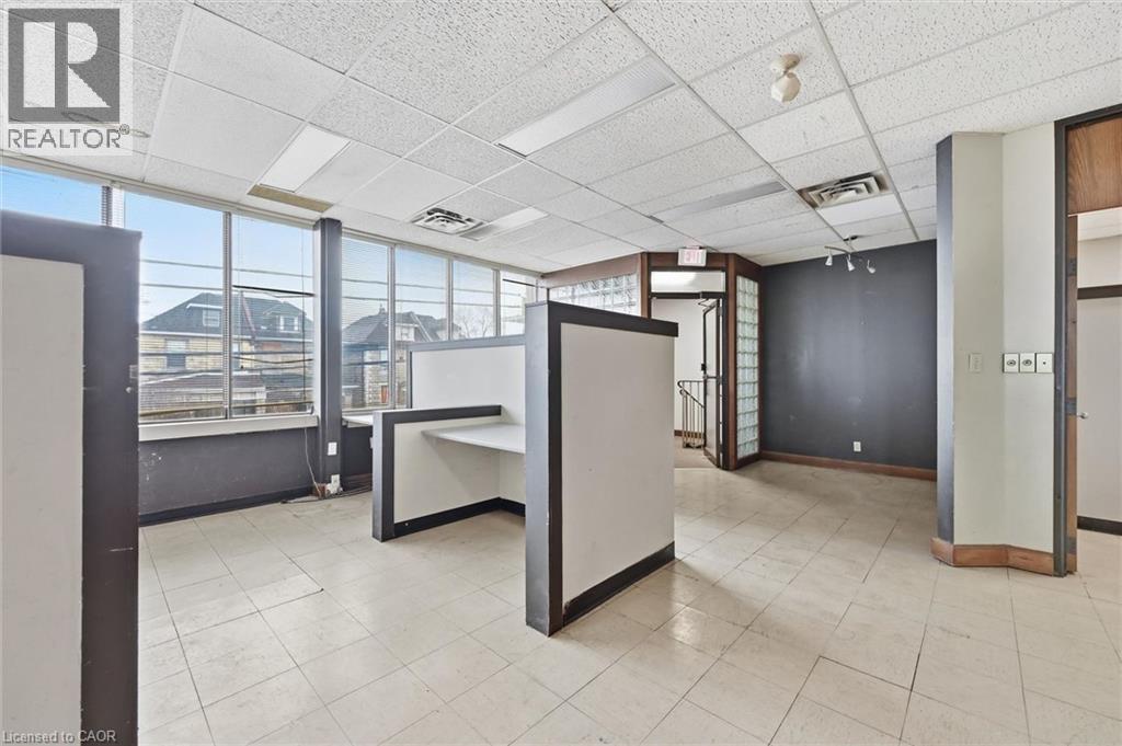 Open commercial space featuring expansive window walls providing natural light - 869 Barton Street E, Hamilton, ON